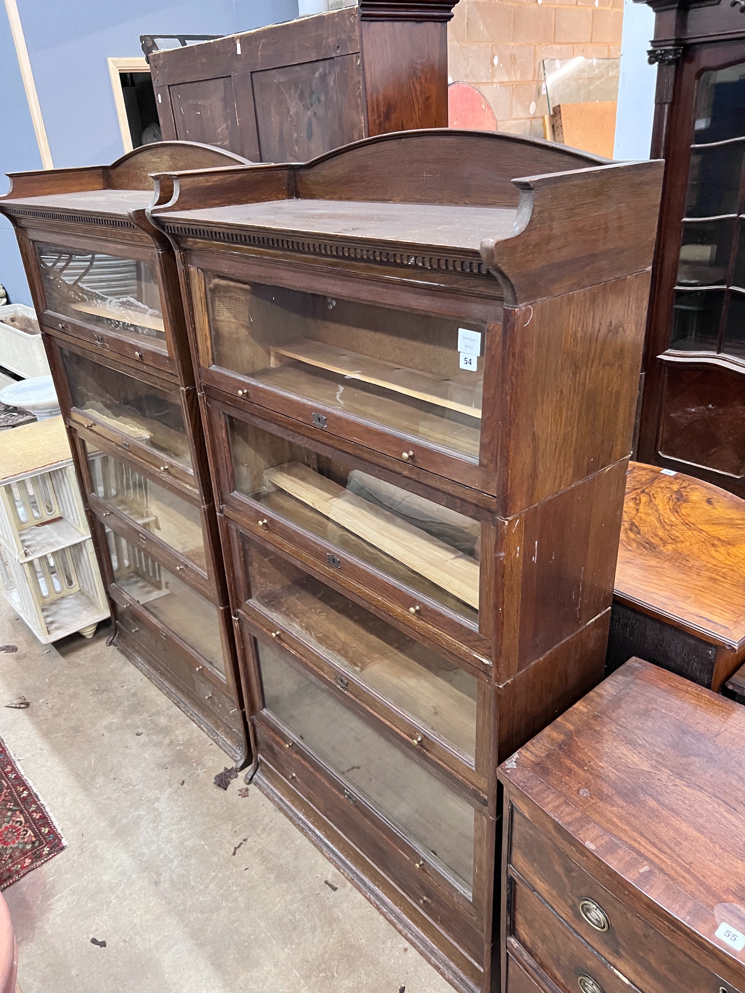 A pair of Edwardian two tier oak Lebus four section bookcases, width 89cm, depth 36cm, height 166cm *Please note the sale commences at 9am.